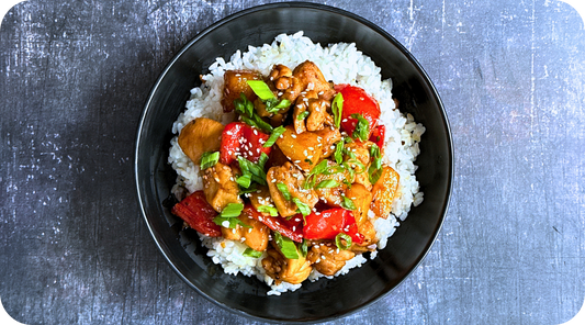 sweet and spicy pineapple chicken in a bowl over rice