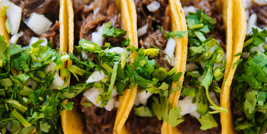image of street tacos with beef, onion and cilantro with corn tortillas