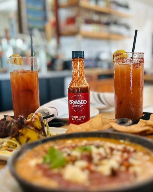 Bloody Marias served with a bottle of Bravado Spice Arbol Chili & Garlic hot sauce.