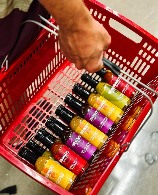 Bravado Spice Co.’s hot sauces, carried by a customer in a red cart.