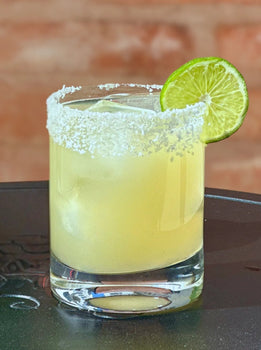 Salt-rimmed classic margarita with fresh lime, made with Bravado Spice Co. Classic Margarita Mixer.