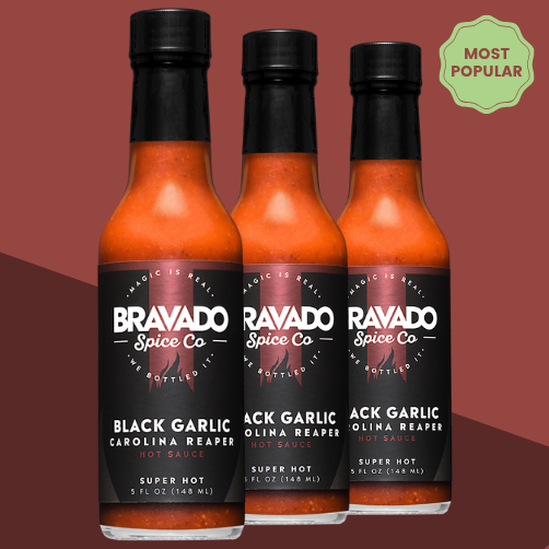 Three bottles of Bravado Spice Co Black Garlic Carolina Reaper Hot Sauce labeled "Most Popular" and "Super Hot" - extreme Carolina Reaper sauce.