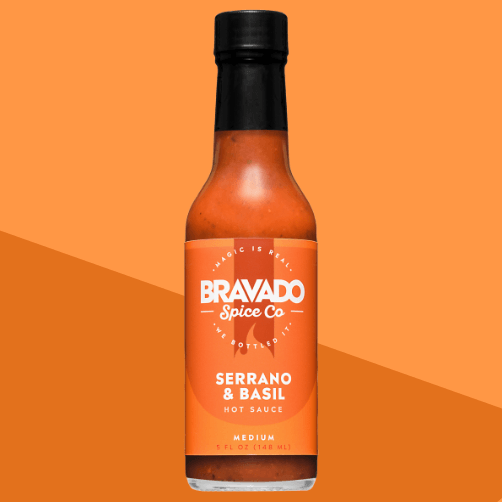 Bravado Spice Co. Serrano & Basil Hot Sauce bottle with green label, blending bright serrano heat and aromatic basil for fresh flavor.