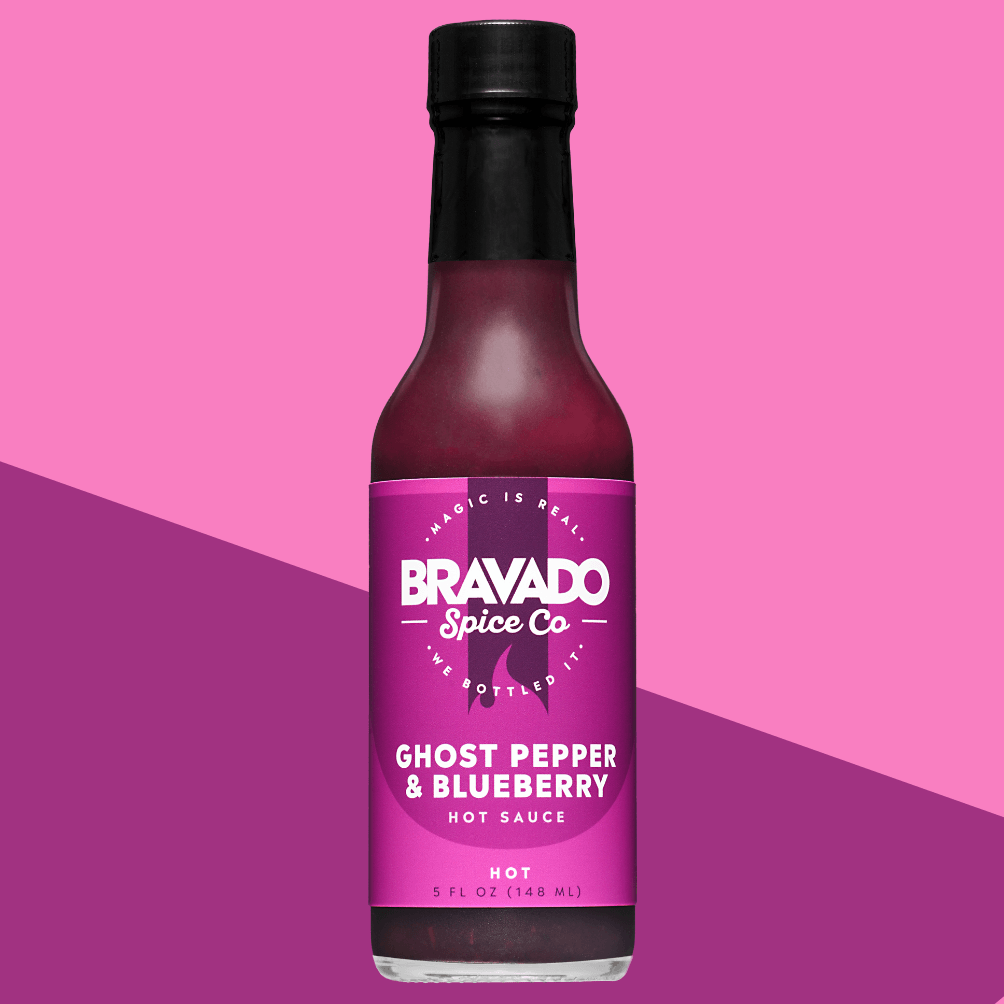 Bravado Spice Co. Ghost Pepper & Blueberry Hot Sauce bottle with deep purple label, combining sweet berry flavor and fiery ghost pepper heat.